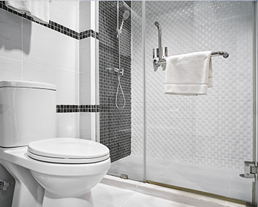 Minimalist bathroom with glass shower enclosure.