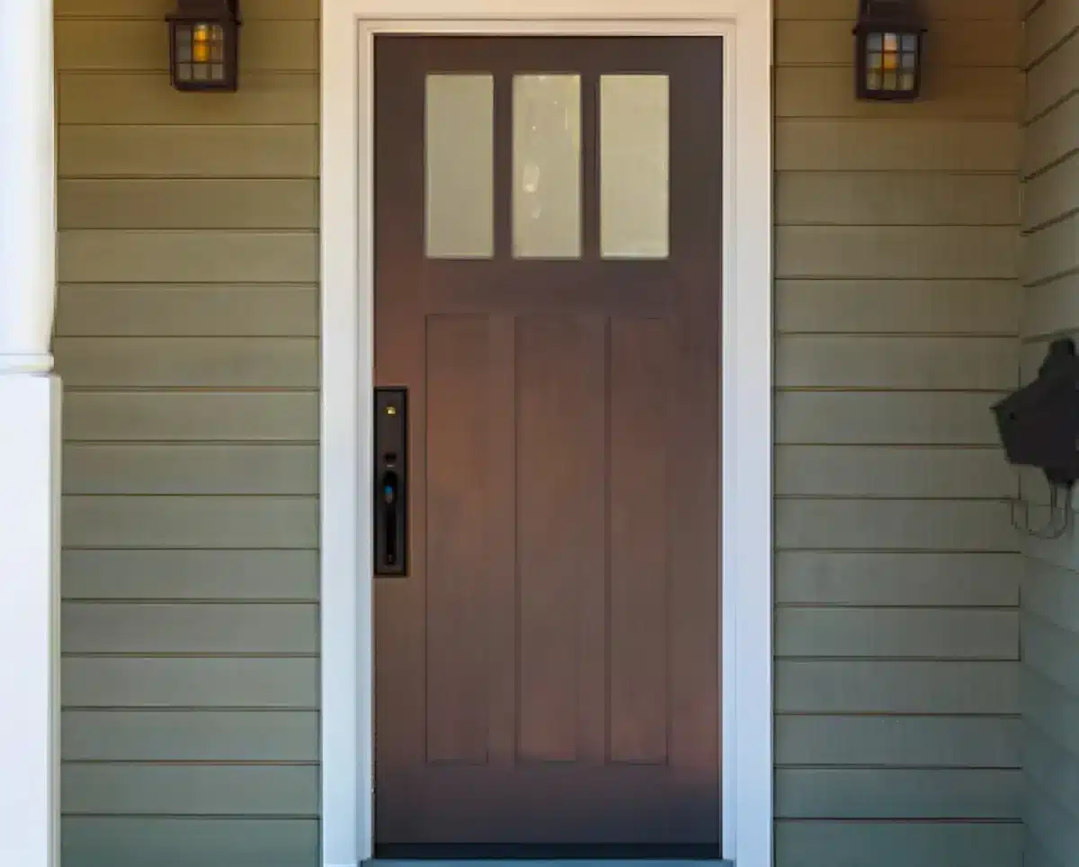 Brown front door with sidelights.